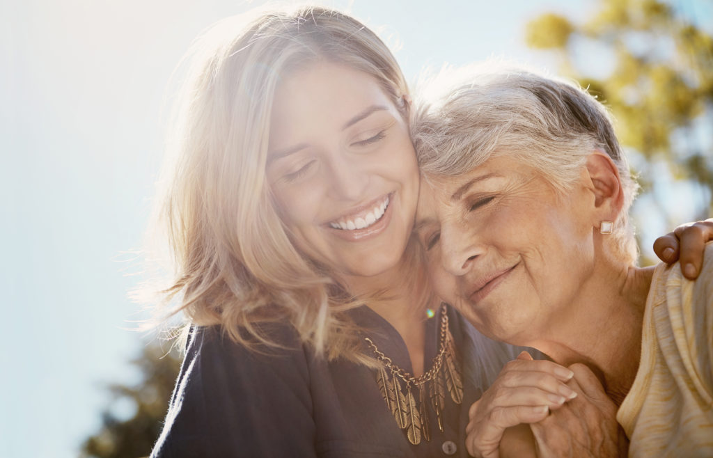 Image of two women smiling in the sunlight