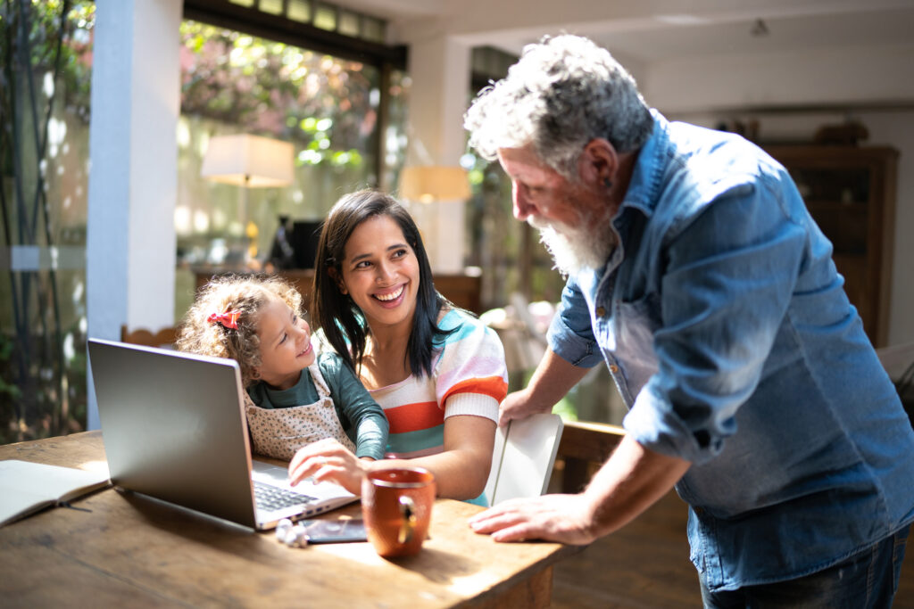 Sandwich generation caregiver works from home while caring for her daughter and father.